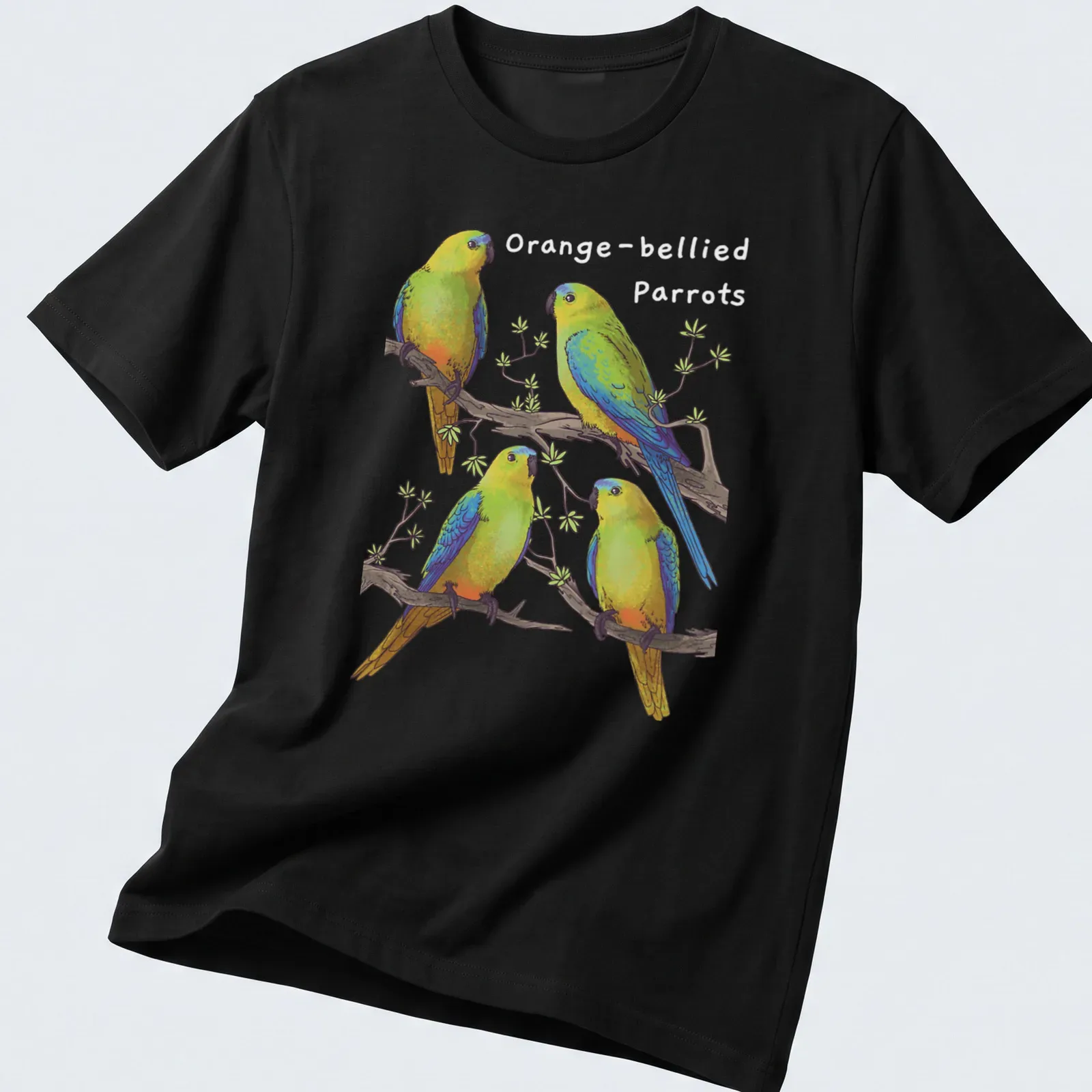 Illustration of four colorful parrots perched on branches in green, blue, yellow, and orange — printed on a unisex t-shirt