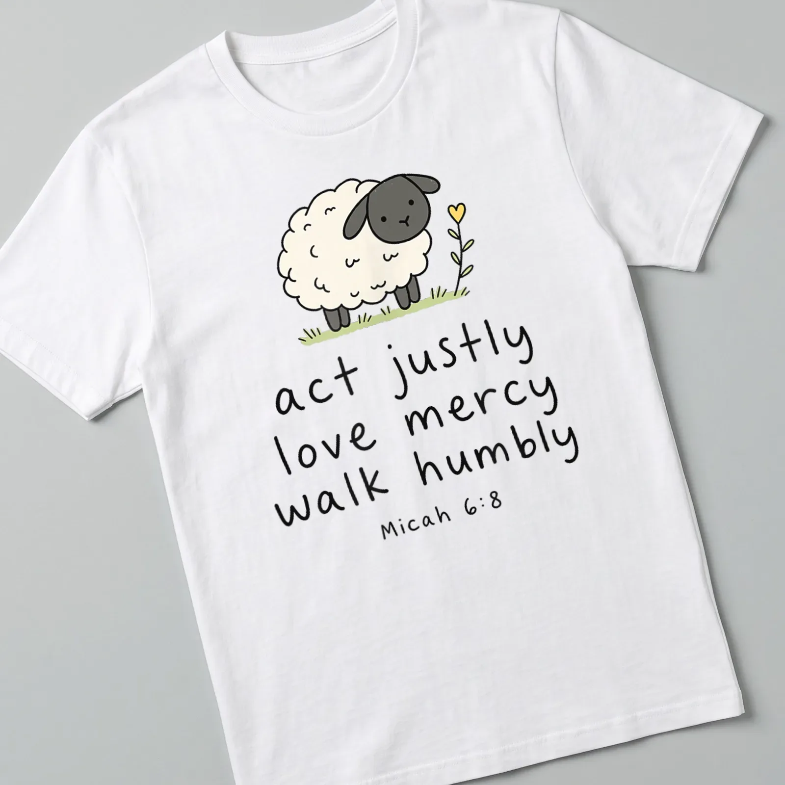 Kawaii illustration of a sheep with text about justice and mercy — printed on a unisex t-shirt