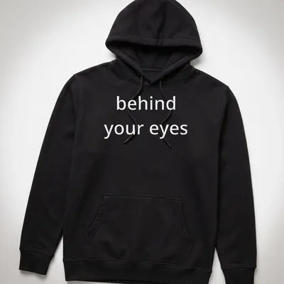 Typographic design featuring the phrase 'behind your eyes' on a minimalist T-shirt. — printed on a unisex hoodie