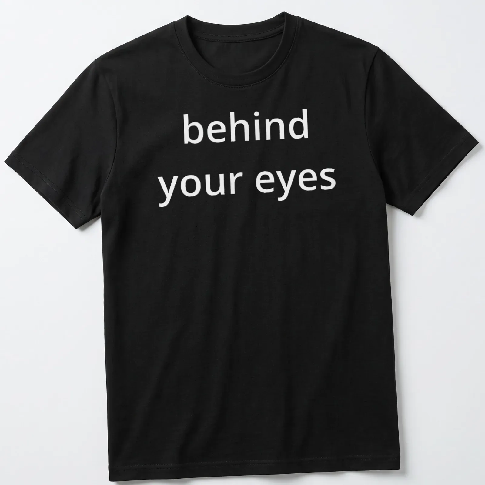 Typographic design featuring the phrase 'behind your eyes' on a minimalist T-shirt. — printed on a unisex t-shirt
