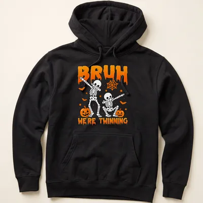 Playful cartoon skeletons with the text Bruh We're Twinning in orange and black — printed on a unisex hoodie