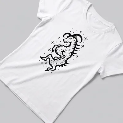 Bold black ink tattoo of a Capricorn Sea Goat in black and white — printed on a women's shirt