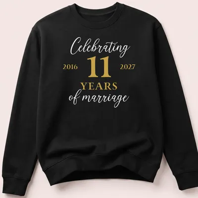 Modern minimalist anniversary t-shirt celebrating 11 years of marriage in gold and white — printed on a unisex sweatshirt
