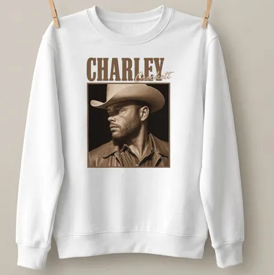 Sepia-tone portrait of cowboy Charley Crockett on — printed on a unisex sweatshirt
