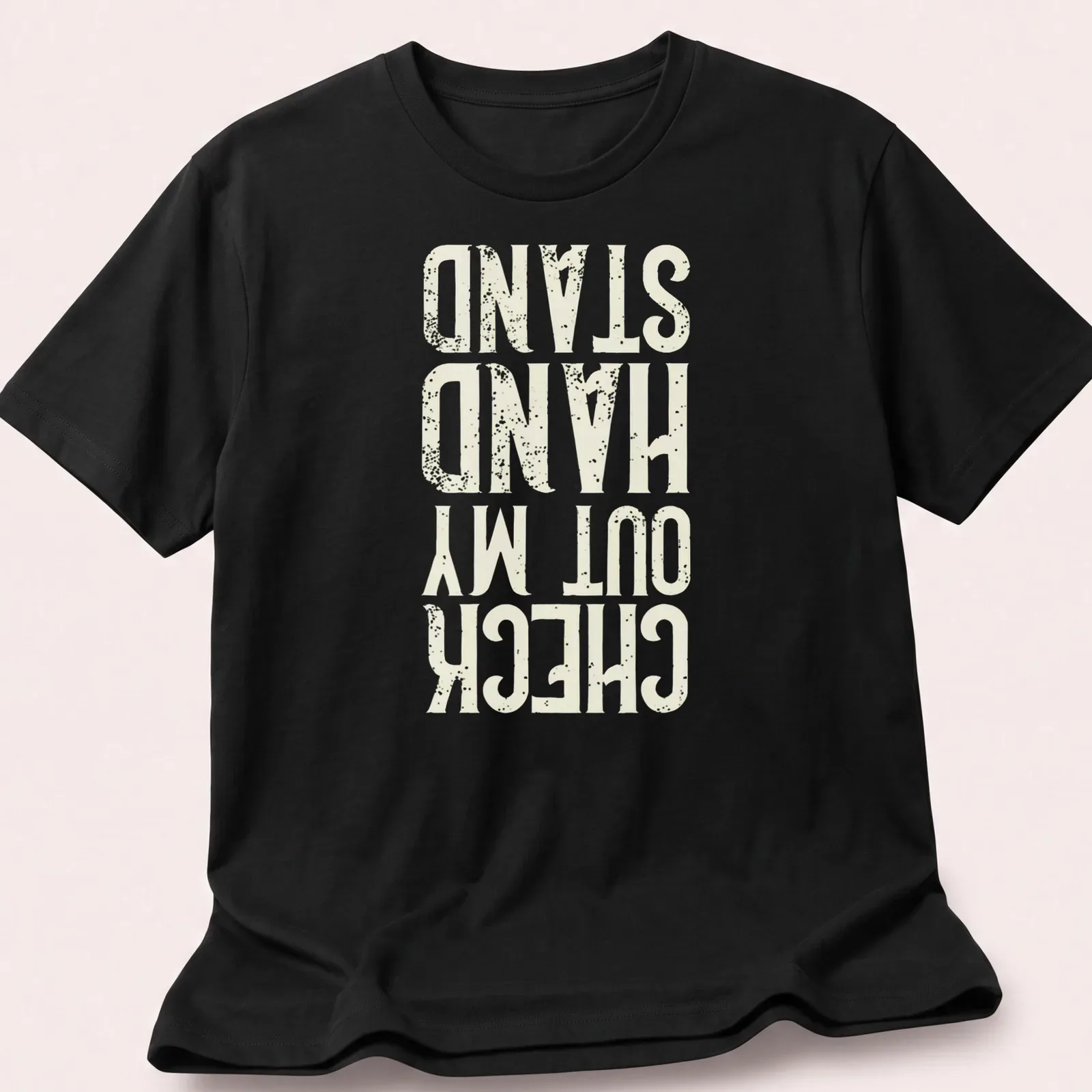 Distressed typography t-shirt featuring the phrase Check Out My Hand Stand in white, cream, and gold. — printed on a unisex t-shirt