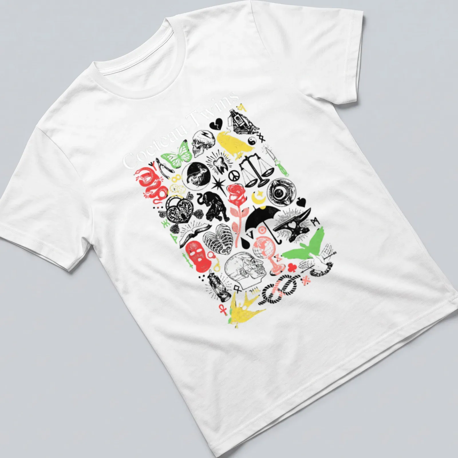 Vintage collage of Cocteau Twins text with skulls and butterflies in vibrant colors — printed on a unisex t-shirt