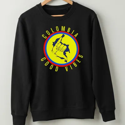 Graphic of a cheerful hand gesture with the text Colombia Good Vibes in vibrant colors — printed on a unisex sweatshirt