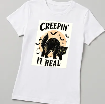 Vintage illustration of a playful black cat with Halloween text — printed on a women's shirt