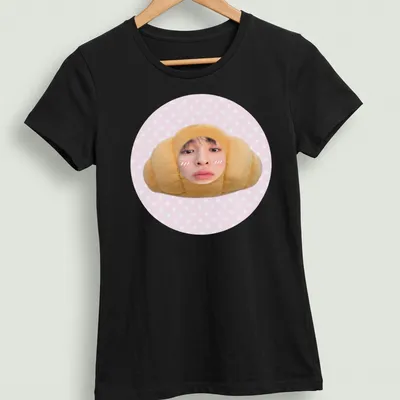 Kawaii cute croissant t-shirt featuring a smiling croissant character in pink and beige — printed on a women's shirt