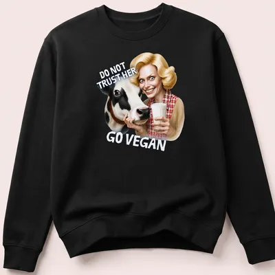 Cartoon cow graphic with bold text urging veganism in playful colors — printed on a unisex sweatshirt