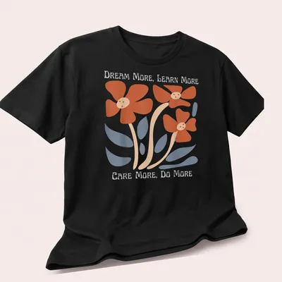 Floral design featuring uplifting text in orange, blue, beige, and white — printed on a unisex t-shirt (angled view)
