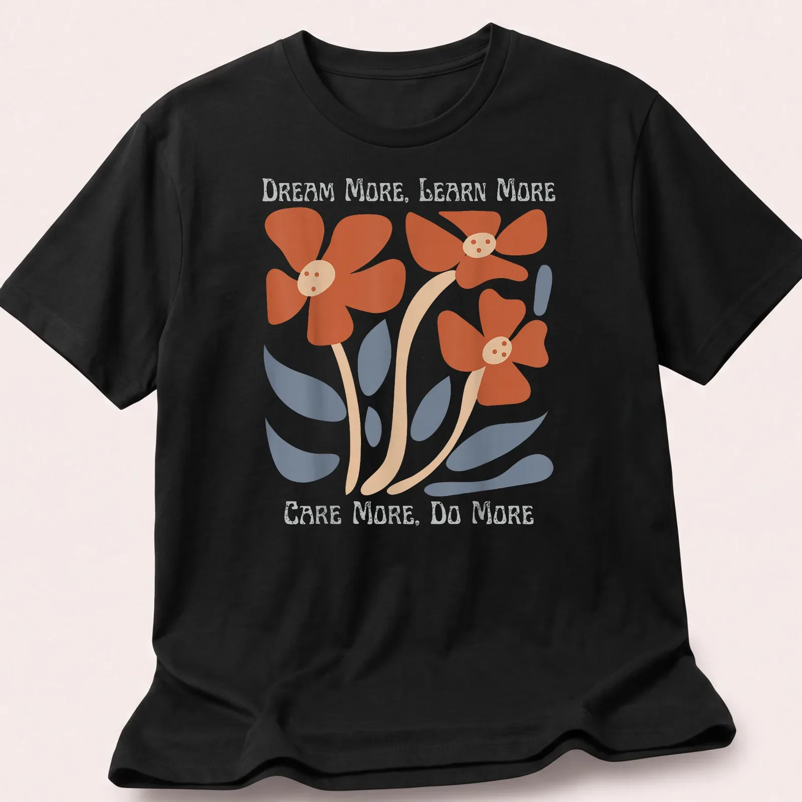 Floral design featuring uplifting text in orange, blue, beige, and white — printed on a unisex t-shirt
