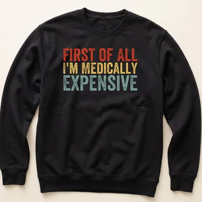 Bold retro humor shirt with text 'First Of All I’m Medically Expensive' in bright colors — printed on a unisex sweatshirt