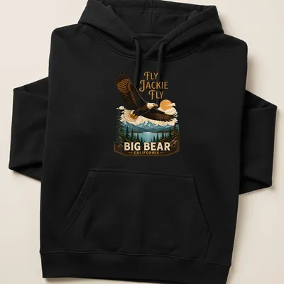 Vintage landscape tee featuring an eagle in flight with the text Fly Jackie Fly Big Bear California — printed on a unisex hoodie