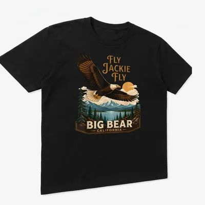 Vintage landscape tee featuring an eagle in flight with the text Fly Jackie Fly Big Bear California — printed on a unisex t-shirt (angled view)