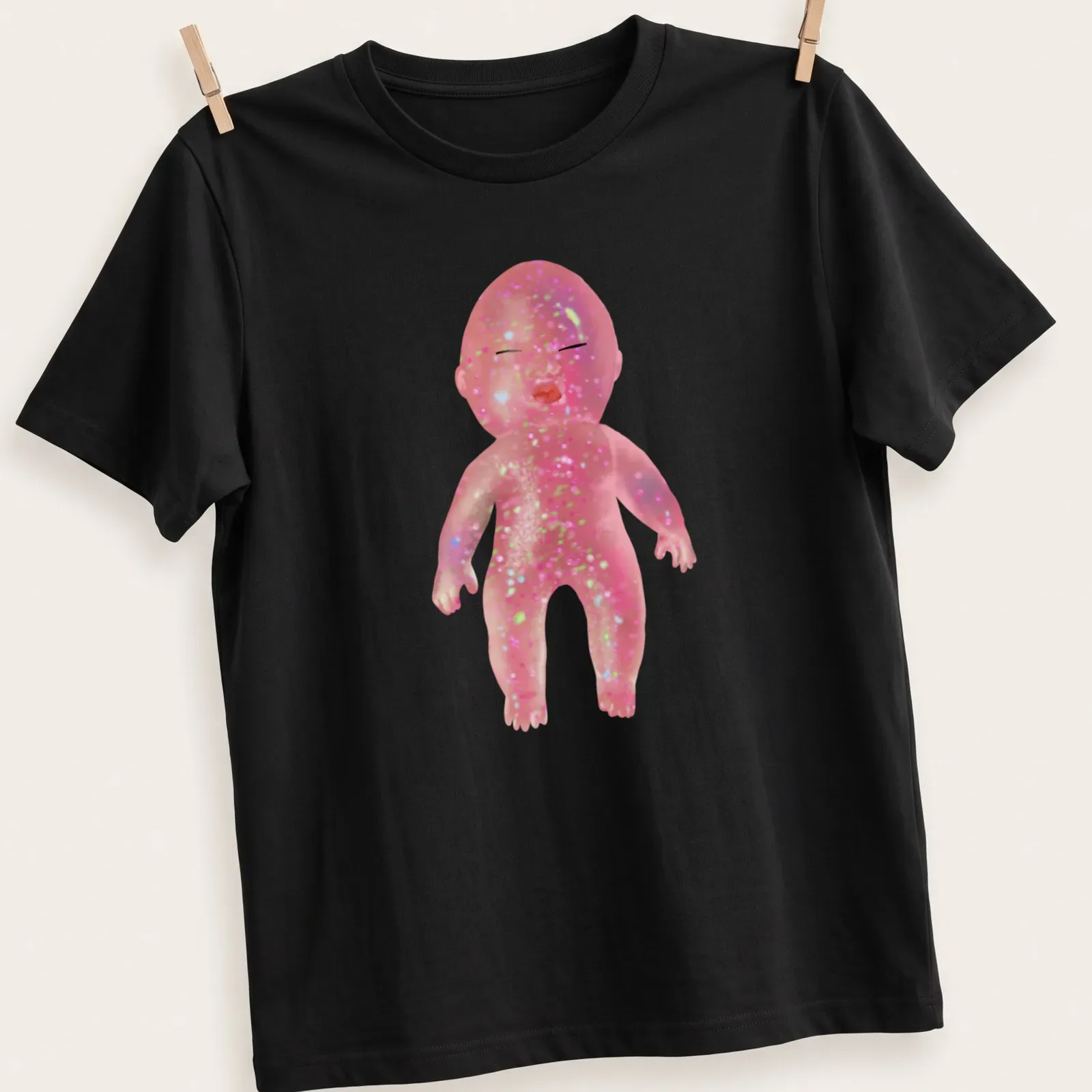 Whimsical illustration of a glittery baby doll with colorful details — printed on a unisex t-shirt