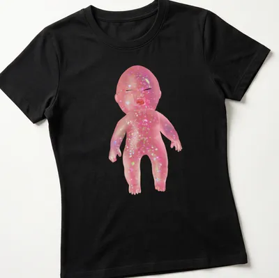 Whimsical illustration of a glittery baby doll with colorful details — printed on a women's shirt