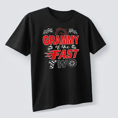 Bold graphic t-shirt with text 'GRAMMY of the FAST TWO' and a racing car illustration in red, black, white, and yellow — printed on a unisex t-shirt (angled view)