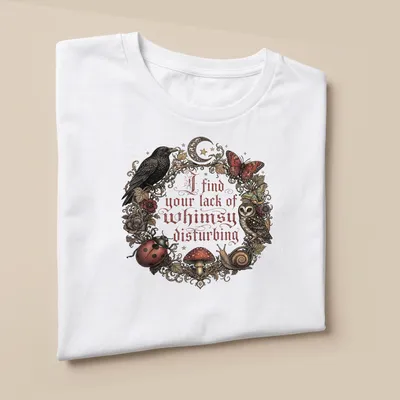 Vintage ornate print of an owl, mushrooms, and other forest creatures with whimsical text — printed on a unisex t-shirt (angled view)