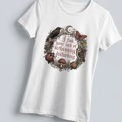 Vintage ornate print of an owl, mushrooms, and other forest creatures with whimsical text — printed on a women's shirt