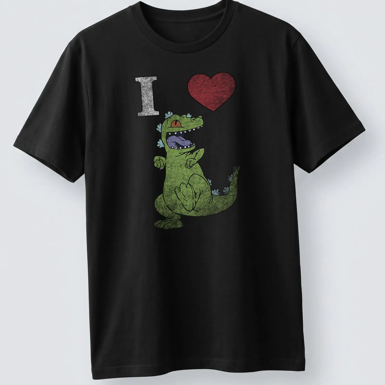 Cartoon dancing dinosaur with text 'I Heart' in playful colors — printed on a unisex t-shirt