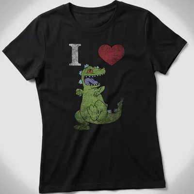 Cartoon dancing dinosaur with text 'I Heart' in playful colors — printed on a women's shirt