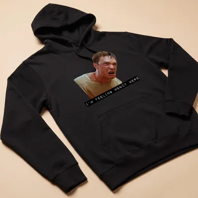Digital illustration of an angry character with the text 'I'M FEELING WOOZY HERE' — printed on a unisex hoodie