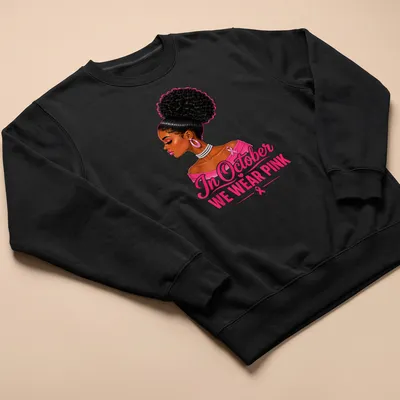 Vibrant illustration of an Afro woman with text 'In October WE WEAR PINK' — printed on a unisex sweatshirt