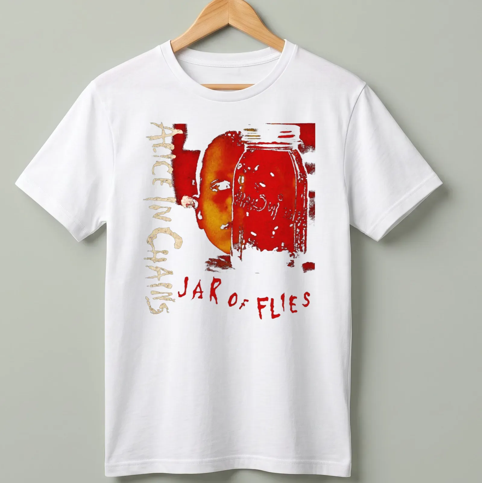 Artistic design of a jar with a face and 'Alice In Chains Jar of Flies' text in red and gold — printed on a unisex t-shirt