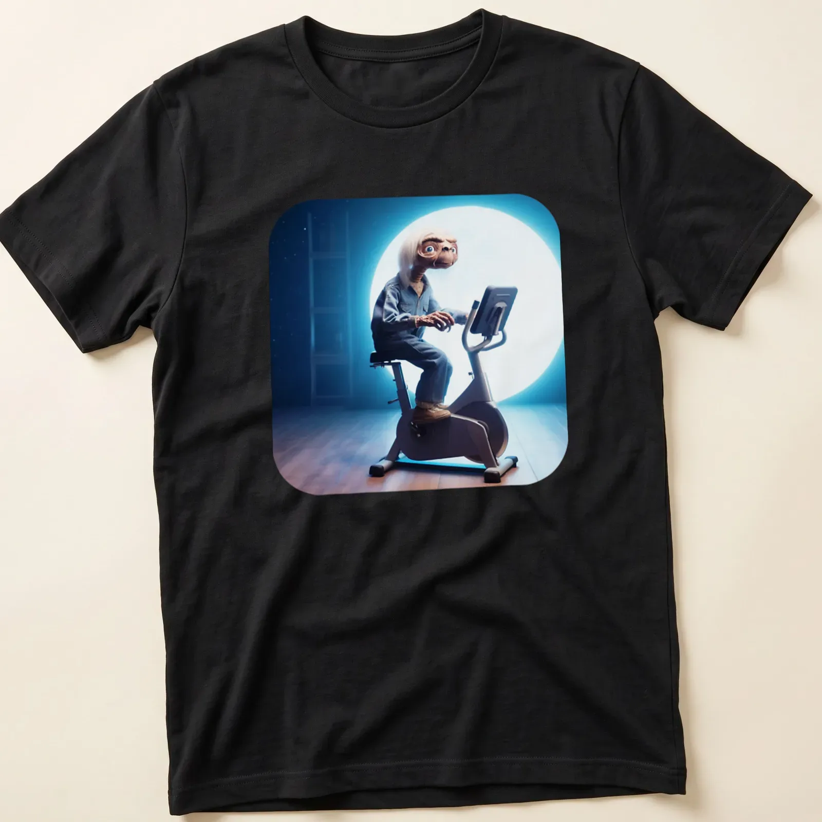 Realistic illustration of an alien on an exercise bike with the text Kosmita Na Rehabilitacji — printed on a unisex t-shirt