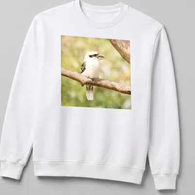 Realistic photo of a laughing kookaburra bird on a branch — printed on a unisex sweatshirt
