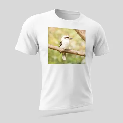 Realistic photo of a laughing kookaburra bird on a branch — printed on a unisex t-shirt (angled view)