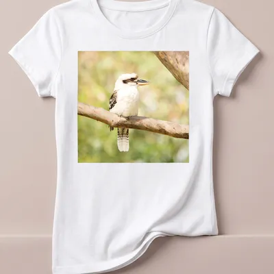 Realistic photo of a laughing kookaburra bird on a branch — printed on a women's shirt