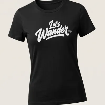 Vintage camping scene with trees, tent, and text 'LET'S WANDER' in earthy colors — printed on a women's shirt
