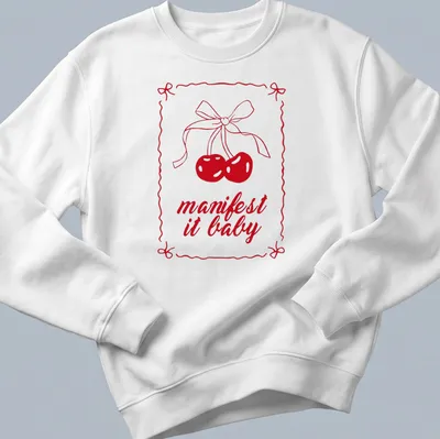 Kawaii line-art shirt with cherries and a bow, featuring "manifest it baby" text — printed on a unisex sweatshirt