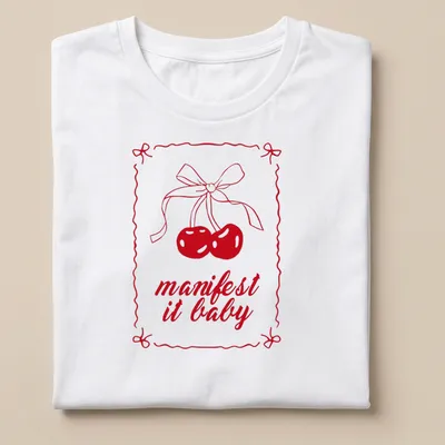 Kawaii line-art shirt with cherries and a bow, featuring "manifest it baby" text