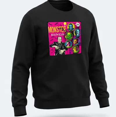 Vintage comic-style t-shirt featuring colorful monster faces and bold 'MONSTER RINGS' text — printed on a unisex sweatshirt