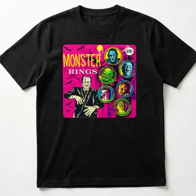 Vintage comic-style t-shirt featuring colorful monster faces and bold 'MONSTER RINGS' text