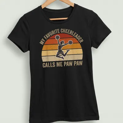 Retro style shirt with text about being a proud Paw Paw and a cheerleader graphic — printed on a women's shirt