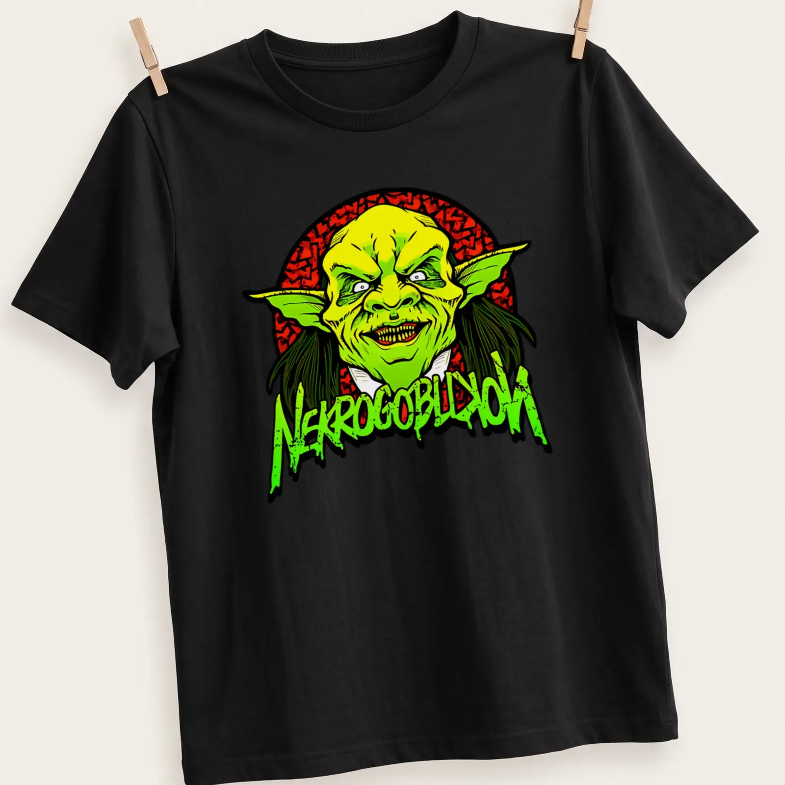Bold cartoon goblin graphic with NEKROGOBLIKON text in green and red. — printed on a unisex t-shirt