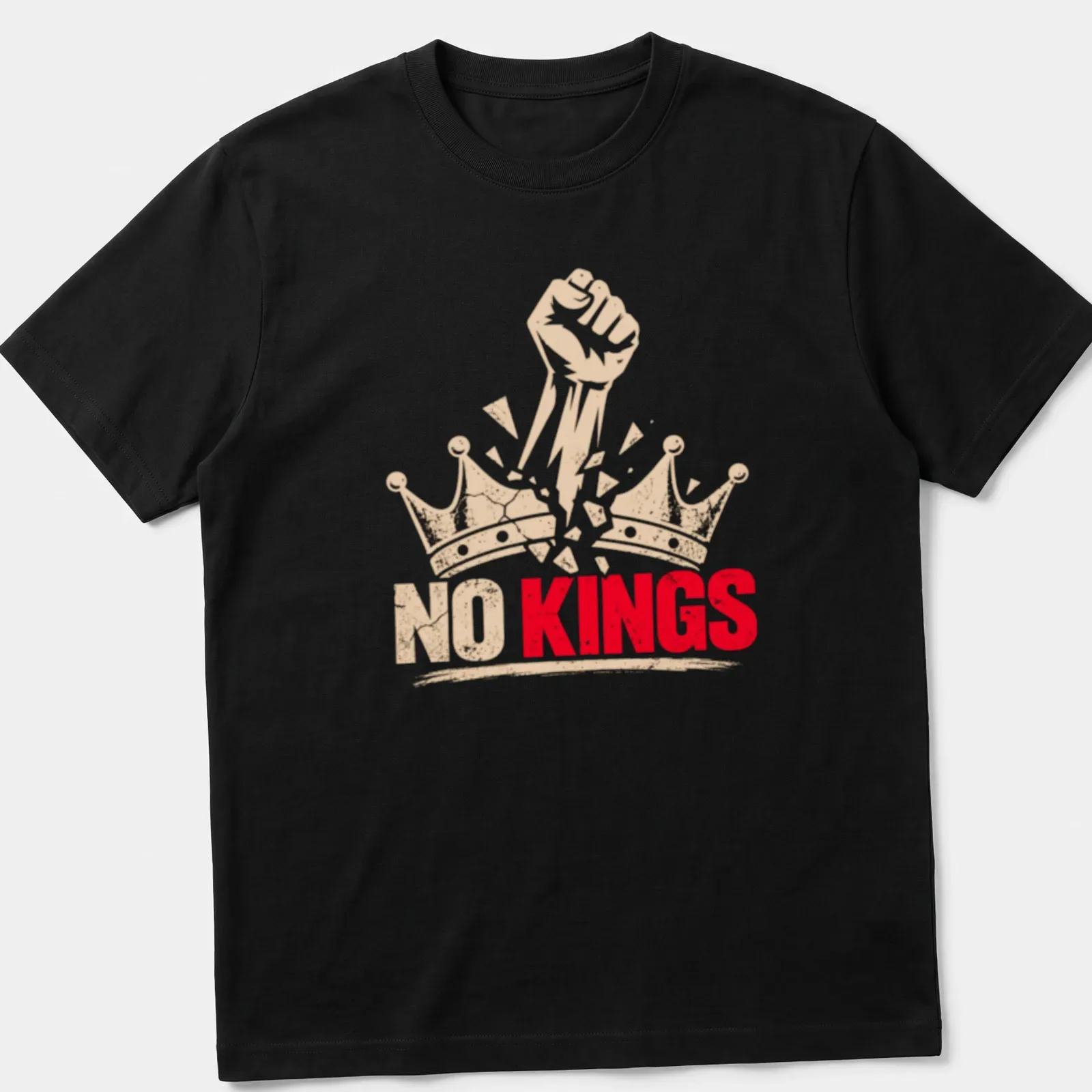 Bold graphic of a fist breaking through crowns with text 'NO KINGS' — printed on a unisex t-shirt