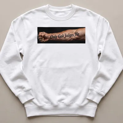 Bold script t-shirt with tattoo design reading 'Only God Judges Me' on an arm — printed on a unisex sweatshirt