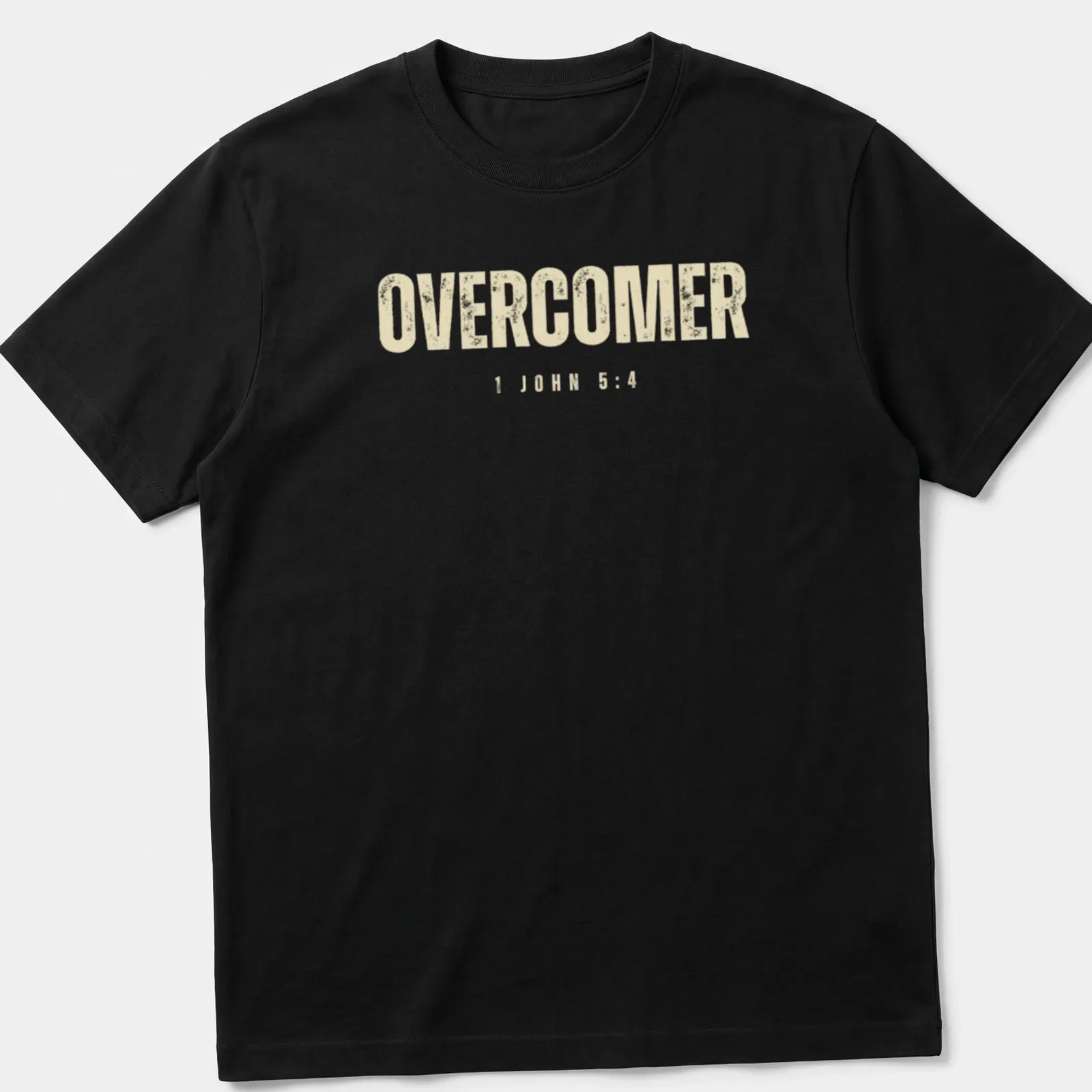 Christian faith t-shirt featuring the text 'OVERCOMER 1 JOHN 5:4' in bold, distressed lettering — printed on a unisex t-shirt