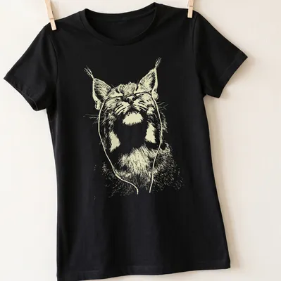 Minimalist line-art of a bobcat listening to music in light beige and white. — printed on a women's shirt