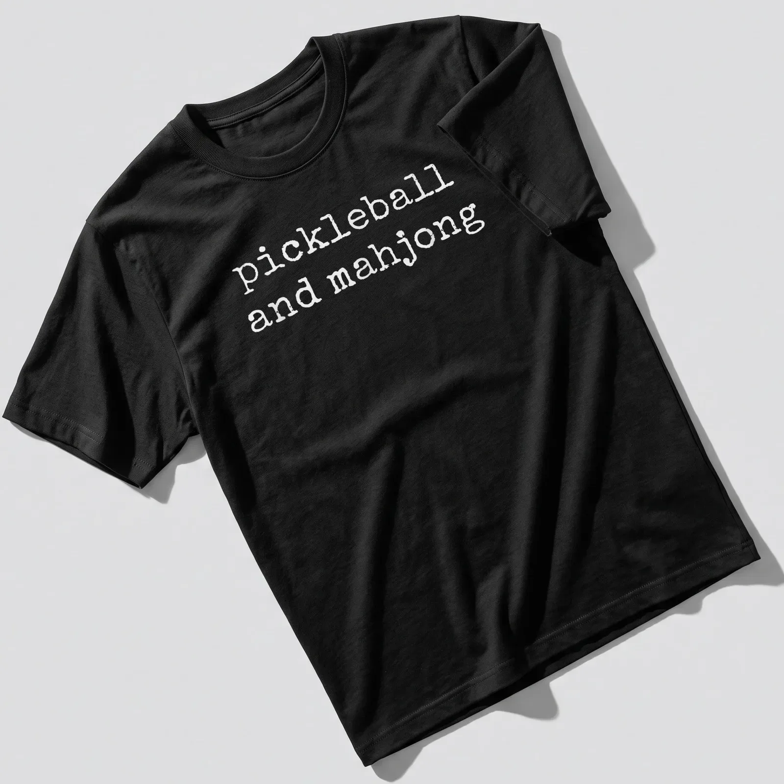 T-shirt featuring simple text design of pickleball and mahjong — printed on a unisex t-shirt