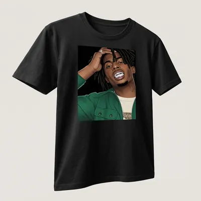 Illustration of Playboi Carty in bold vector art with green and black elements — printed on a unisex t-shirt (angled view)