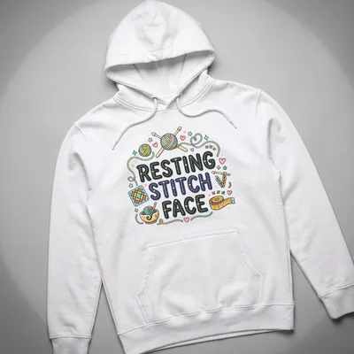 Colorful whimsical design featuring crochet yarn and knitting tools with text 'Resting Stitch Face' — printed on a unisex hoodie
