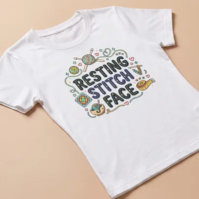 Colorful whimsical design featuring crochet yarn and knitting tools with text 'Resting Stitch Face' — printed on a women's shirt