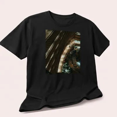 Illustration of a kingfisher perched in a river scene with modern architectural style — printed on a unisex t-shirt (angled view)