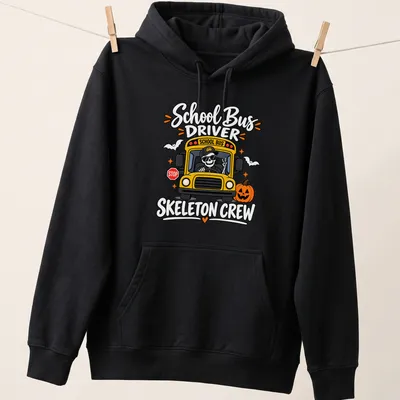 Cartoonish print of a cheerful skeleton school bus driver with vibrant colors — printed on a unisex hoodie